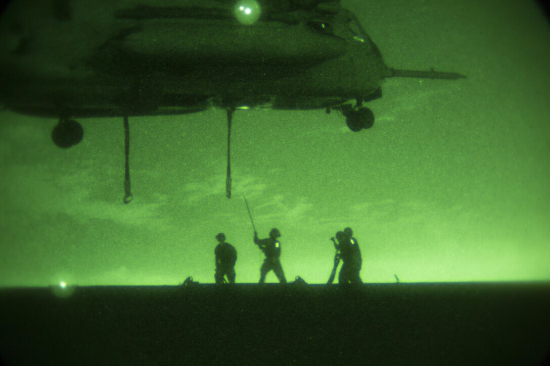 Marines with Combat Logistics Battalion 13 prepare to attach a 6,200 pound steel girder to a CH-53E Super Stallion helicopter from Marine Medium Tiltrotor Squadron 166, 3rd Marine Aircraft Wing, during external lift training aboard Marine Corps Air Station Miramar, Calif., Oct. 14. The squadron conducted the training to maintain proficiency in transporting external cargo. (Official Marine Corps photo by Sgt. Brian Marion/Released)