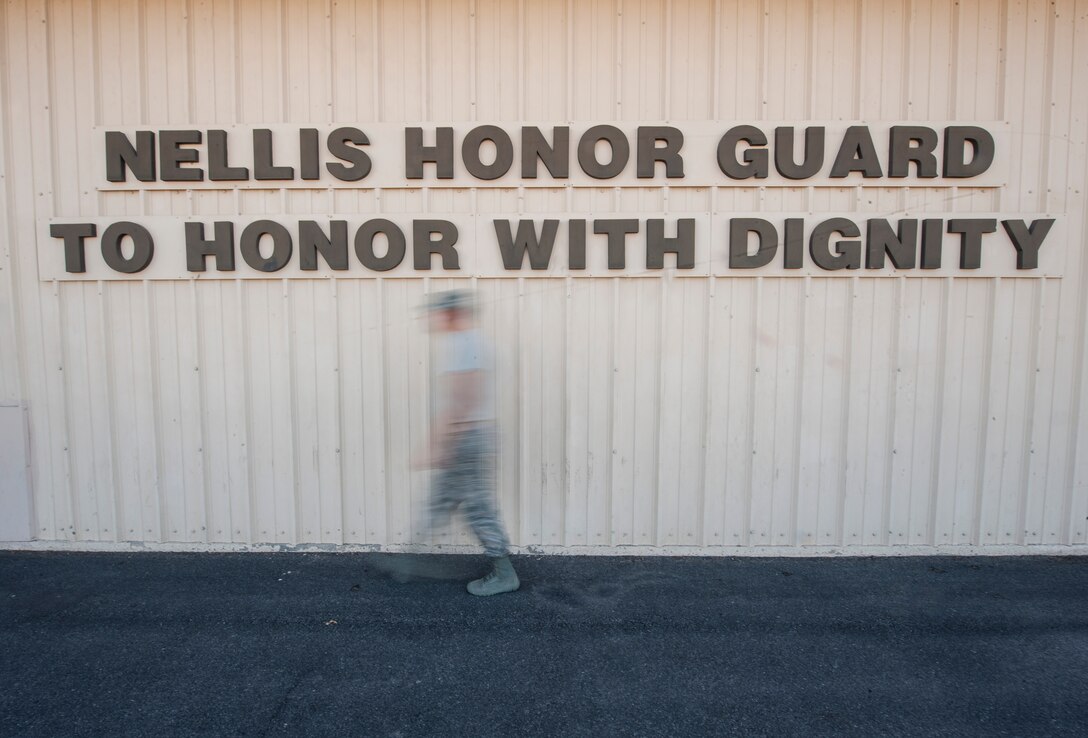 A member of the Nellis Air Force Base Honor Guard walks during a team practice session at Nellis AFB, Oct. 13, 2015. The Nellis AFB Honor Guard’s mission is “To honor with dignity” and each member is reminded of that when they see the front of the team’s building. (U.S. Air Force photo by Staff Sgt. Siuta B. Ika)