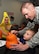 An Airman helps his son draw on a pumpkin during the Montana Air National Guard Airman and Family Readiness Program Halloween party held for children of guardsmen at the 120th Airlift Wing in Great Falls, Mont., Oct. 14, 2015.  (U.S. Air National Guard photo by Senior Master Sgt. Eric Peterson/Released)

