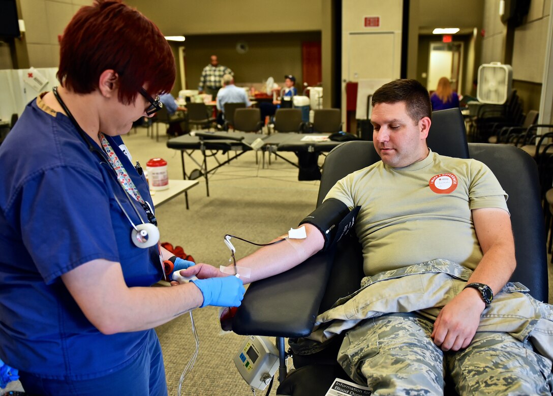 Capt. Christopher Kaighen, commander, 932nd Logistics Readiness Flight, donates a double dose of blood during the Red Cross blood drive, October 15, 2015, 932nd Airlift Wing headquarters building, Scott Air Force Base, Illinois.  At times of need for certain blood types, The Red Cross is able to do double red cell donations.  A process similar to whole blood donation, except a special machine is used to allow the blood donor to safely donate two units of red blood cells with plasma and platelets returned to the donor.  (U.S. Air Force photo by Christopher Parr)