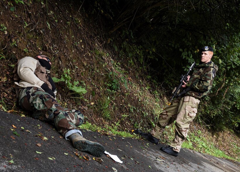 Staff Sgt. Zachary Lindquist, 911th Security Forces Squadron patrolman, apprehends a suspect during a chemical, biological, radiological, nuclear and explosives exercise here, October 4, 2015. Lindquist and fellow SFS airmen are trained and ready to counter threats to any Air Force installation on which they are stationed. (U.S. Air Force photo by Staff Sergeant Justyne Obeldobel)