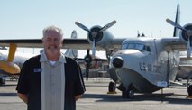 Rick Shea, Travis Heritage Center curator, stands in front of a SA-16 Albatross on Oct. 13 at the heritage center at Travis Air Force Base, Calif. Shea returned to Travis as a civilian employee in July after an active-duty stint at the Bay Area base during the late 1970s. (U.S. Air Force photo by Airman 1st Class Amber Carter)