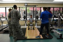 Miguel Larrera, doctor of physical therapy intern, gives a proper form demonstration Oct. 9 at David Grant USAF Medical Center at Travis Air Force Base, Calif. Larrera showed Airmen how to bench press with proper form to prevent injuries. (U.S. Air Force photo by Airman 1st Class Amber Carter)