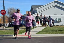 Attendees from the breast cancer awareness event run to show their support of the cause Oct. 15, 2015, at Malmstrom Air Force Base, Mont. Men, women and children of all ages participated in the event to help raise awareness. (U.S. Air Force photo/Airman Daniel Brosam)
