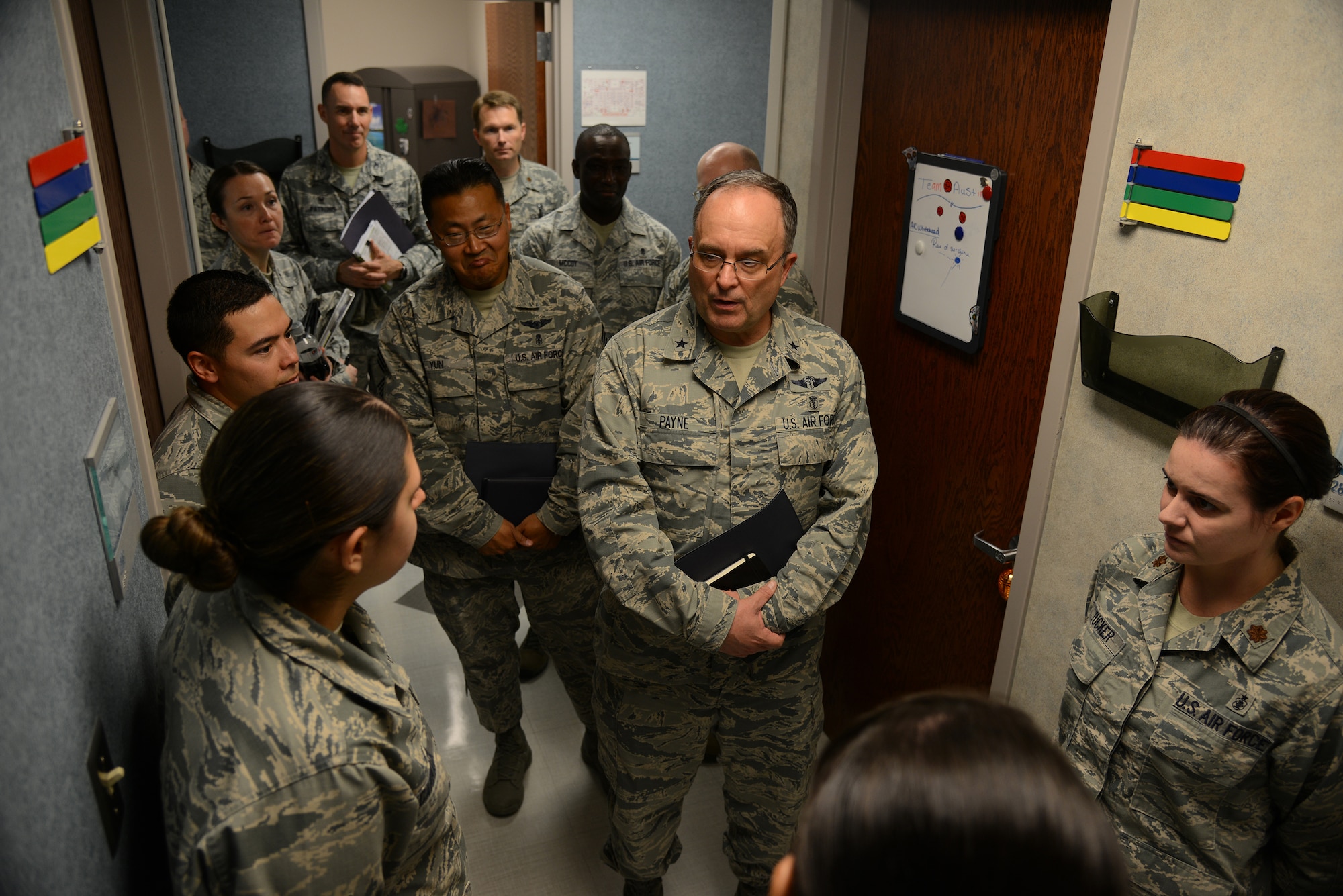 Airman 1st Class Mychaela Cammack, 47th Medical Operations Squadron pediatrics technician, bottom left, briefs Brig. Gen. (Dr.) Lee E. Payne, Air Force Medical Operations Agency commander, at the 47th Medical Group Clinic on Laughlin Air Force Base, Texas, Oct. 15, 2015. The pediatrics clinic was one of twelve units Payne visited during his visit to Laughlin to gain a better perspective of the mission and challenges faced by the unit. (U.S. Air Force photo by Tech Sgt. Steven R. Doty)(Released)