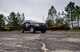 A range police vehicle rolls by old tanks while on patrol Oct. 6 at Eglin Air Force Base, Fla.  The range police are responsible for the safety and security of Eglin range’s mission, people and environment.  (U.S. Air Force photo/Samuel King Jr.)