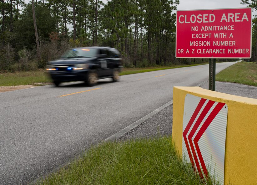 A range police vehicle rolls by a “Closed Area” sign while out on patrol Oct. 6 at Eglin Air Force Base, Fla.  The range police are responsible for the safety and security of Eglin range’s mission, people and environment.  (U.S. Air Force photo/Samuel King Jr.)
