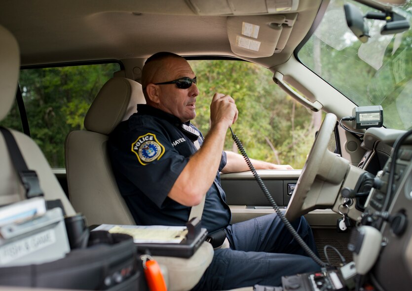 Mike Hayes, a range police officer, communicates via radio while on patrol Oct. 6 at Eglin Air Force Base, Fla.  The range police are responsible for the safety and security of Eglin range’s mission, people and environment.  (U.S. Air Force photo/Samuel King Jr.)