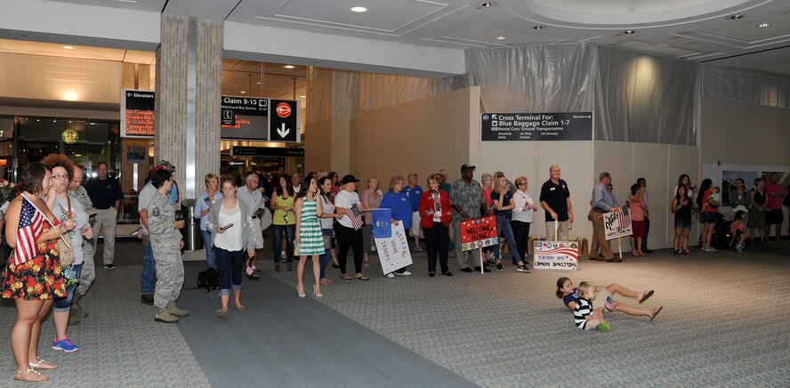 More than two dozen, family members, friends and well-wishers gathered at Tampa International Airport, October 15, to welcome home the first wave of 927 Security Forces Squadron redeployers. During the six month long deployment to an undisclosed location in Southwest Asia, the defenders provided air base defense, force protection and performed anti-terrorism duties. (U.S. Air Force photo/Tech. Sgt. Peter Dean)