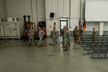 U.S. Air Force Tech. Sgt. Anthony Biecheler, 726th Air Mobility Squadron NCO-in-charge of aircraft services, briefs U.S. Air Force Maj. Gen. Frederick Martin, USAF Expeditionary Center commander and U.S. Air Force Chief Master Sgt. Pete Stone, USAF Expeditionary Center command chief inside a 726th AMS warehouse Oct. 14, 2015, at Spangdahlem Air Base, Germany. Biecheler briefed Martin and Stone on the cargo capabilities of the 726th AMS. (U.S. Air Force photo by Senior Airman Rusty Frank/Released)