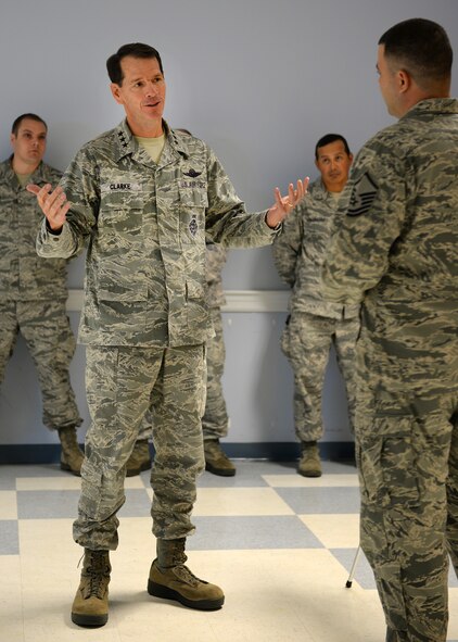 Lt. Gen. Stanley E. “Sid” Clarke III, Air National Guard director, speaks with Master Sgt. Brad Bogue, 157th Force Support Squadron NCO in charge programs, during a visit to Pease Air National Guard Base, New Hampshire, Oct. 15. Clarke is at Pease to hear feedback from Airmen on the ground level and find ways to improve a variety of things that can impact Airmen. He also took time to highlight the many ways they are making a difference. (U.S. Air National Guard photo by Senior Airman Kayla McWalter)