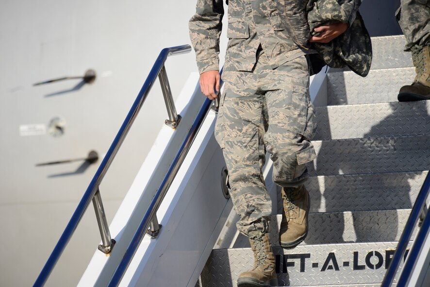 An Airman from the 35th Fighter Wing takes his first steps off the Boeing 767 at Misawa Air Base, Japan, Oct.  16, 2015.  Squadrons from Misawa often deploy worldwide in support of operations requiring the need of the Wild Weasel mission of suppression of enemy air defenses. (U.S. Air Force photo by Tech. Sgt. April Quintanilla/Released)