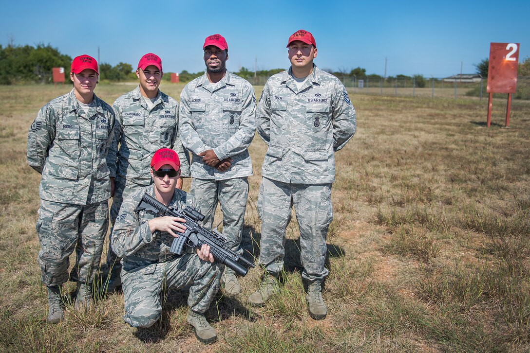 82nd Security Forces Squadron combat arms instructors stand in front of their newly refurbished 203 grenade training range on Sheppard Air Force Base, Texas, Oct. 6, 2015. This team helped rebuild the range, saving the Air Force nearly $13,200 which increased training effectiveness and realism. (U.S. Air Force photo/Senior Airman Kyle Gese)