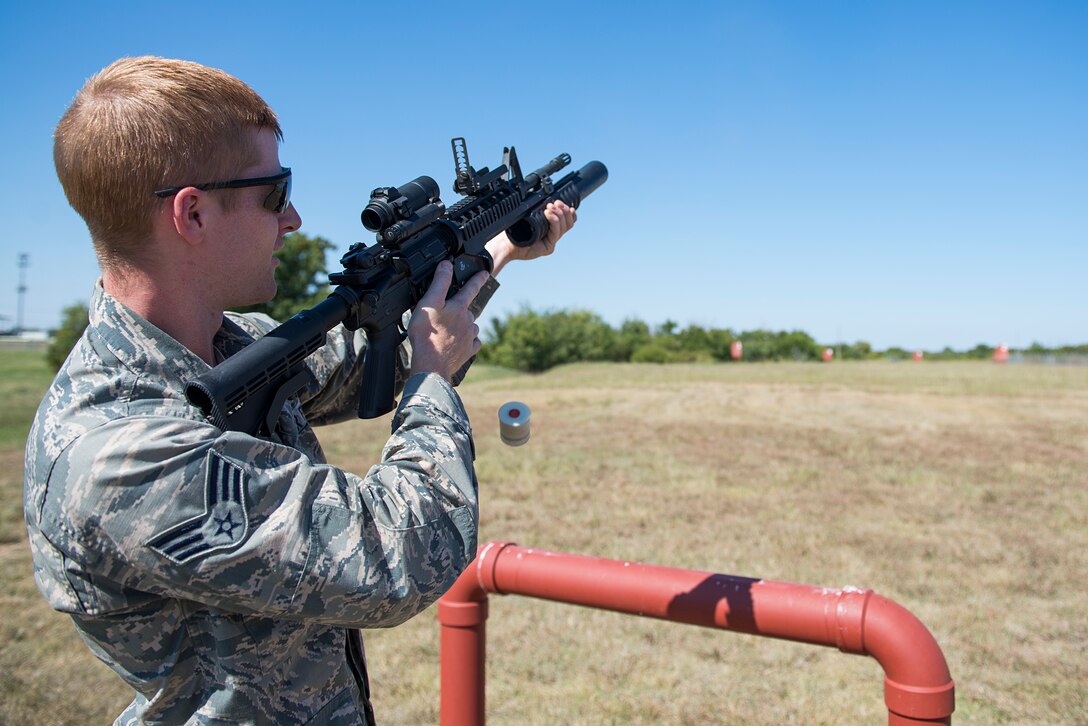 Senior Airman Bradley Primmer, 82nd Security Forces Squadron combat arms instructor, demonstrates the 203 grenade launcher on the newly refurbished 203 grenade training range on Sheppard Air Force Base, Texas, Oct. 6, 2015. He and his team helped rebuild the range, saving the Air Force nearly $13,200 which increased training effectiveness and realism. (U.S. Air Force photo/Senior Airman Kyle Gese)