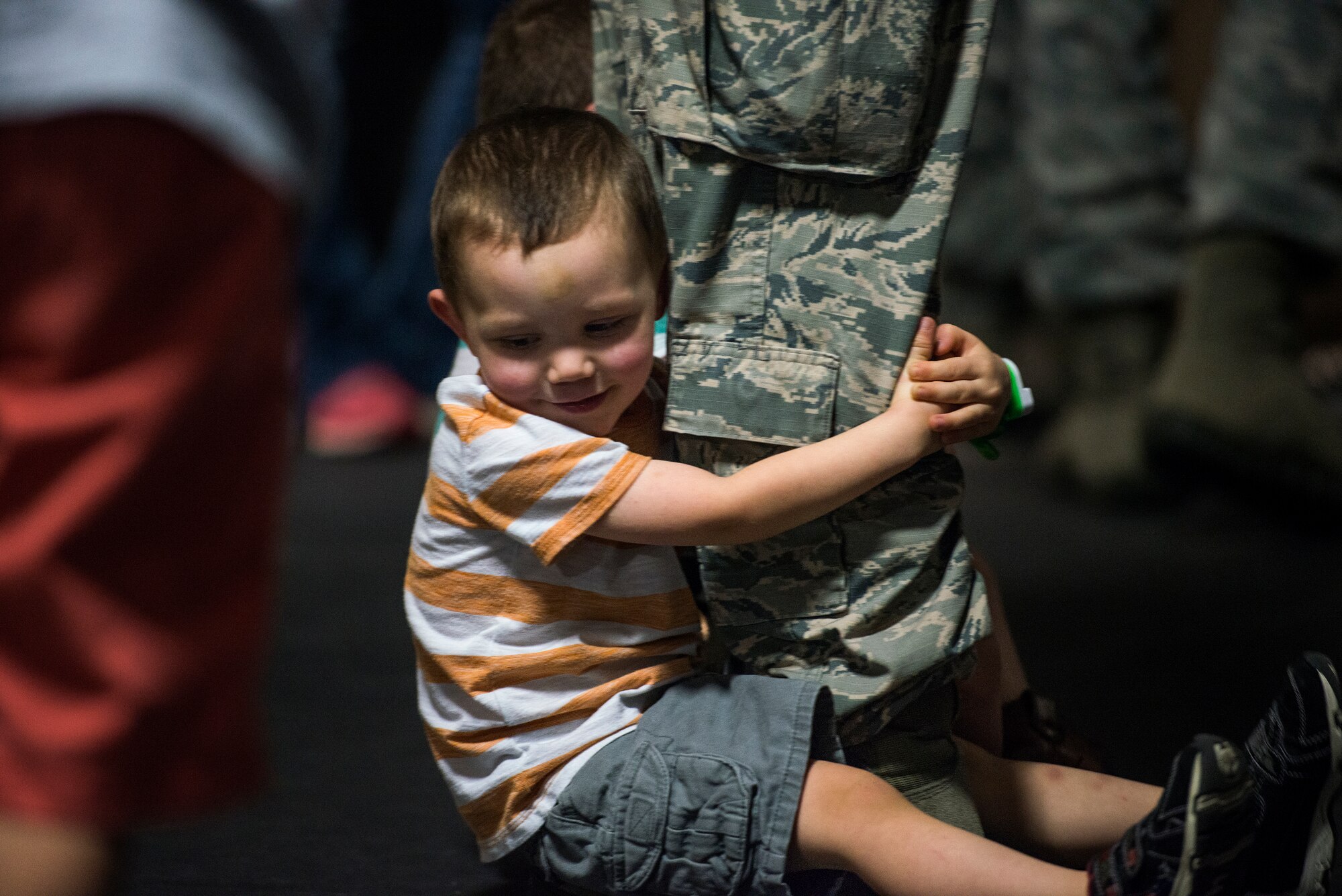 U.S. Air Force Staff Sgt. John Hughes, 824th Base Defense Squadron fire team leader, plays with his son during the 824th Base Defense Squadron deployment ceremony, Oct. 16, 2015, at Moody Air Force Base, Ga. The 824th BDS is part of the 820th Base Defense Group which at a moment's notice, can provide the expeditionary Air Force's only worldwide deployable, first-in, fully integrated, multi-disciplined, highly qualified, self-sustaining force protection capability. (U.S. Air Force photo/Senior Airman Ryan Callaghan/Released)
