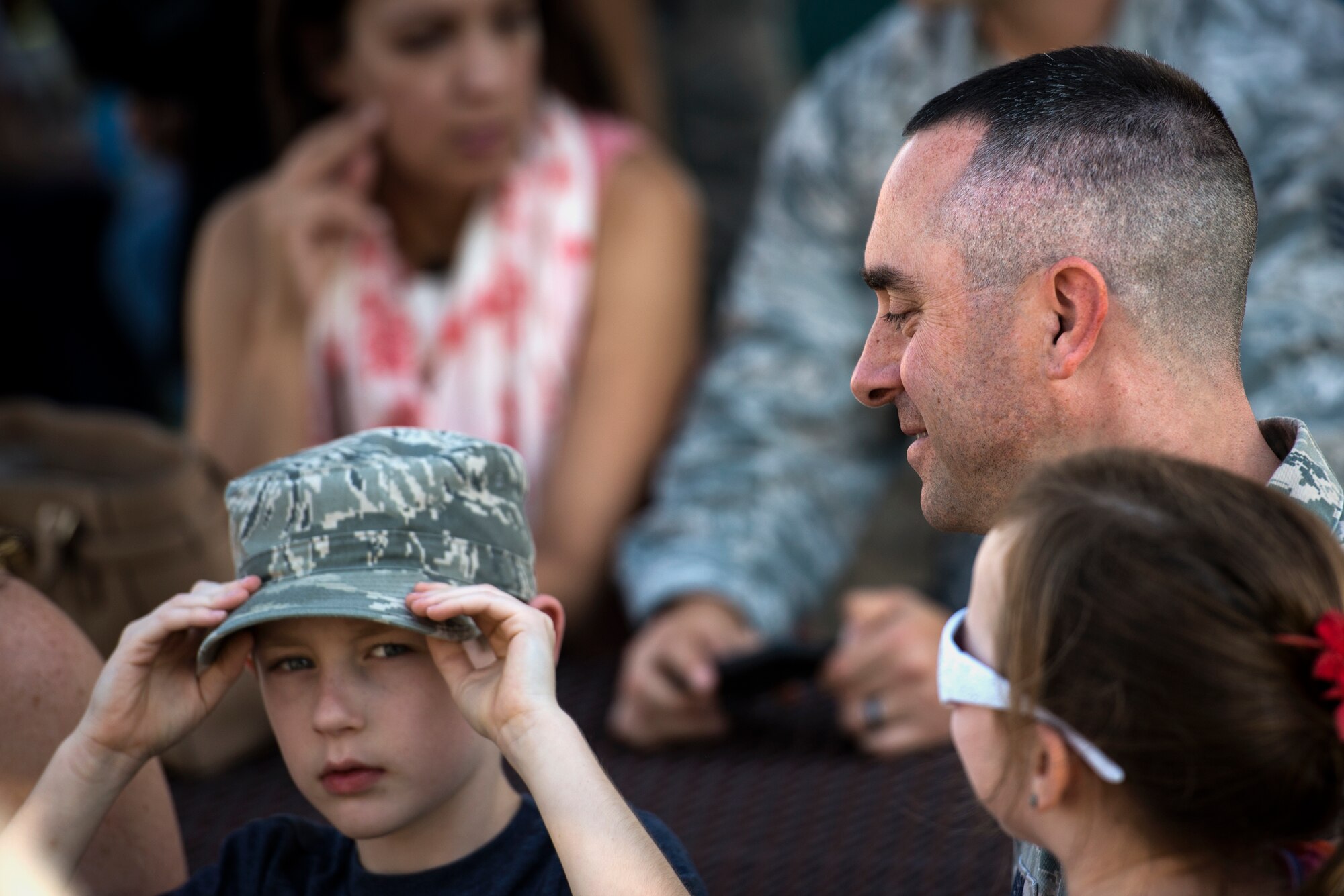 U.S. Air Force Master Sgt. Keith Anson, 824th Base Defense Squadron first sergeant, laughs with his son during the 824th BDS deployment ceremony, Oct. 16, 2015, at Moody Air Force Base, Ga. The 824th BDS provides fully-integrated, highly capable and responsive forces to protect Expeditionary Air Forces. (U.S. Air Force photo/Senior Airman Ryan Callaghan/Released)
