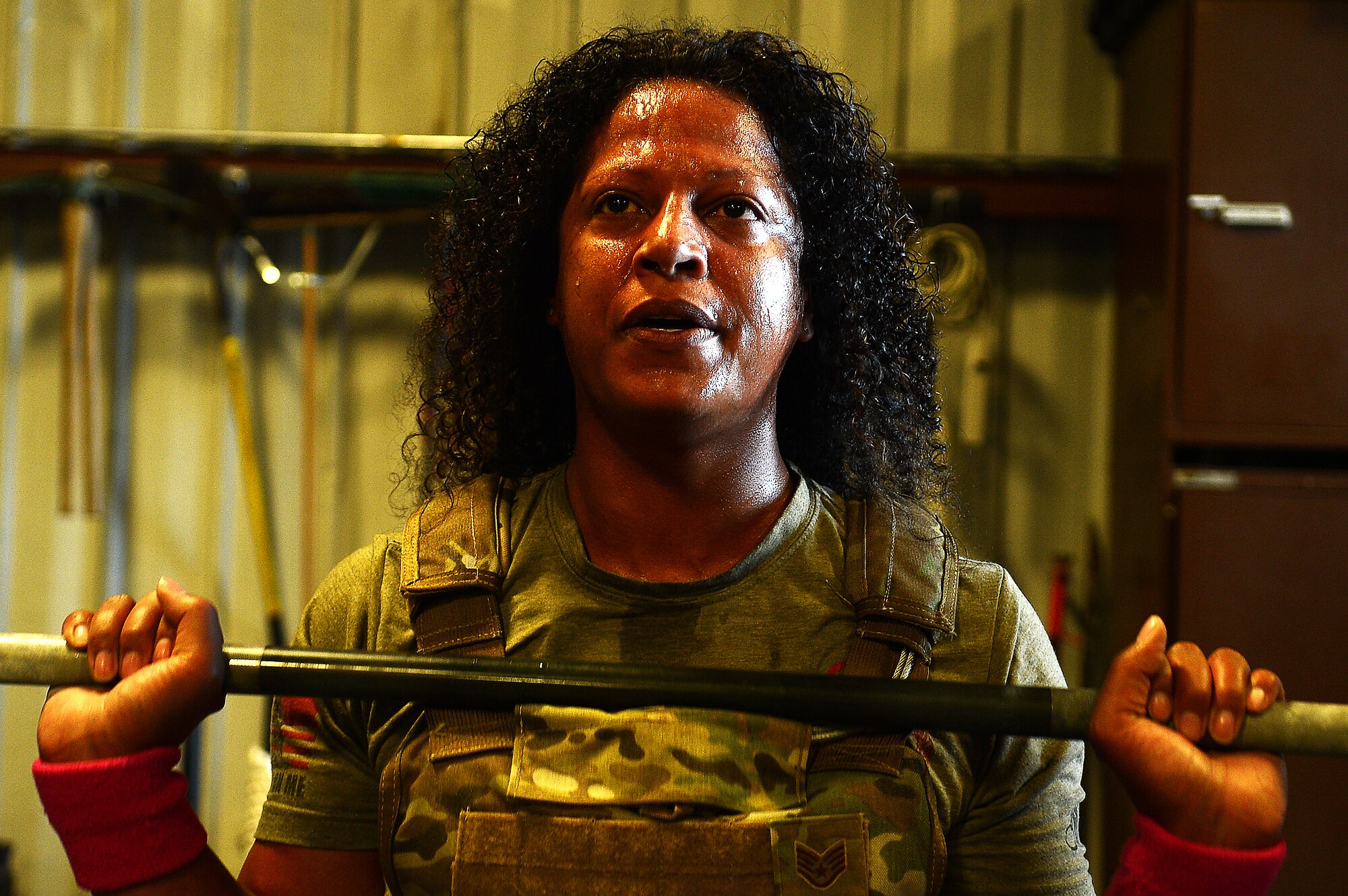 A Team Shaw spouse attempts a power clean during the EOD 130 Memorial Workout at Shaw Air Force Base, S.C., Oct. 15, 2015. The EOD 130 is a workout routine designed to remember the 130 Explosive Ordnance Disposal service members who have fallen in the line of duty since 9/11. (U.S. Air Force photo by Senior Airman Jonathan Bass/Released)
