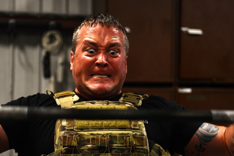 U.S. Air Force Master Sgt. Jeremy Phillips, 20th Civil Engineer Squadron Explosive Ordnance Disposal flight logistics section chief, attempts a power clean during the EOD 130 Memorial Workout at Shaw Air Force Base, S.C., Oct. 15, 2015. Phillips completed the extreme workout in 51 minutes, 12 seconds. (U.S. Air Force photo by Senior Airman Jonathan Bass/Released)