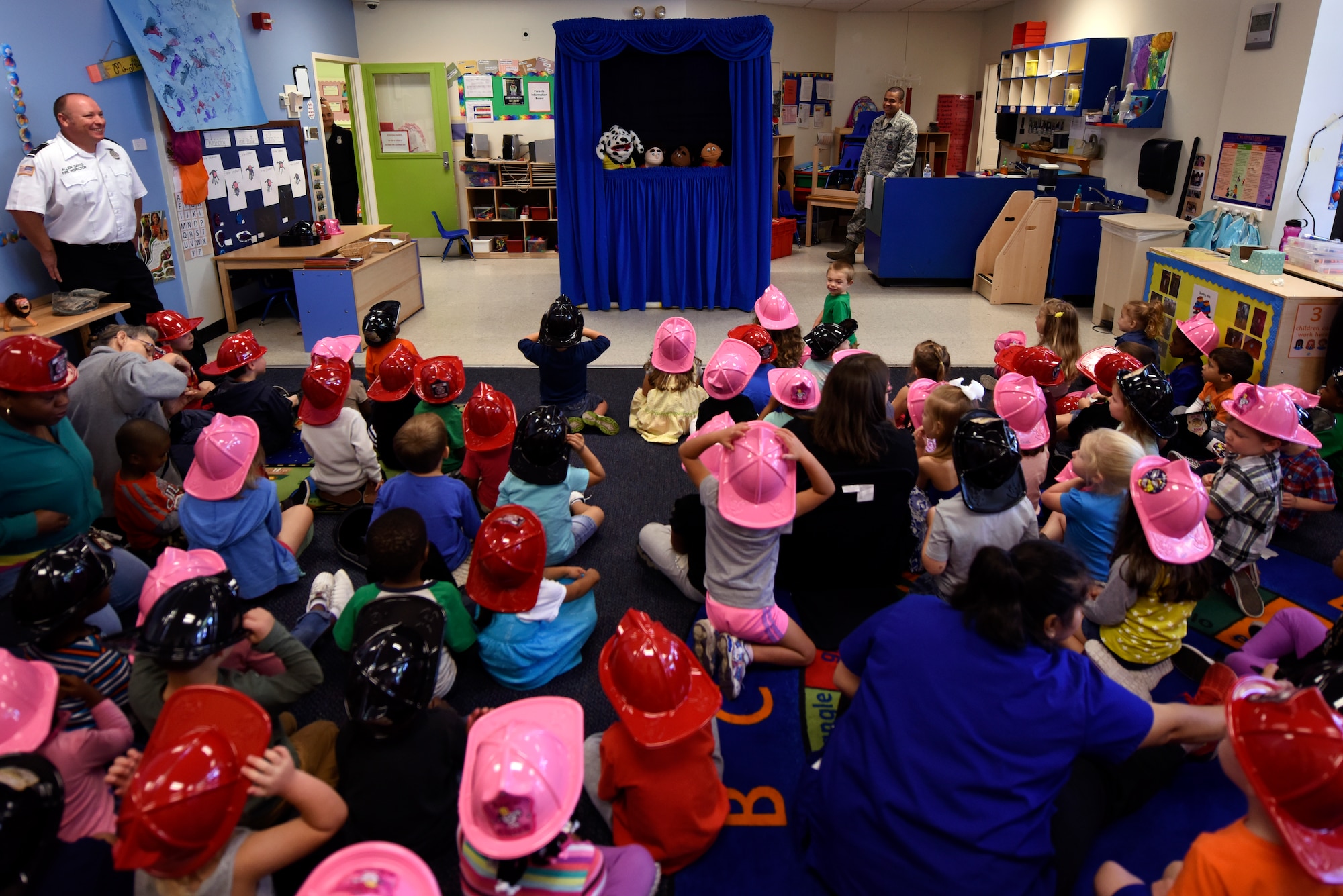 Children at the Child Development Center watch a puppet show put on by the 4th Civil Engineer Squadron fire department as part of Fire Prevention Week, Oct. 8, 2015, at Seymour Johnson Air Force Base, North Carolina. The puppet show was used to both entertain and promote the message of FPW, “Hear the beep where you sleep.” (U.S. Air Force photo/Senior Airman Brittain Crolley)