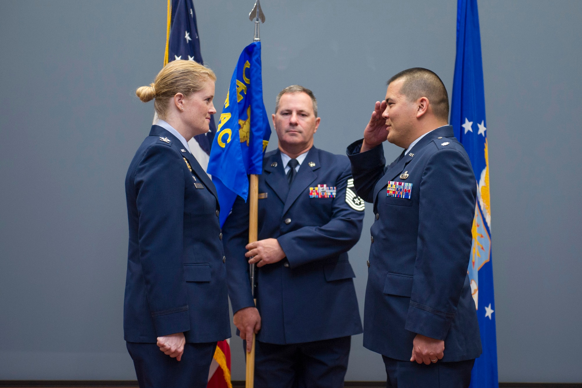 Lt. Col. Dennis Uyechi (right) salutes his commander, Col. Jennifer P. Sovada, as Uyechi assumes command of the newly formed Technical Support Squadron, Air Force Technical Applications Center, Patrick AFB, Fla., Oct. 13, 2015, while Uyechi's superintendent, Chief Master Sgt. Gerald McFadden holds the unit's guidon.  AFTAC conducted five assumption of command and activation ceremonies in October, marking a historic event in the nuclear treaty monitoring center's history.  (U.S. Air Force photo by Matthew Jurgens)