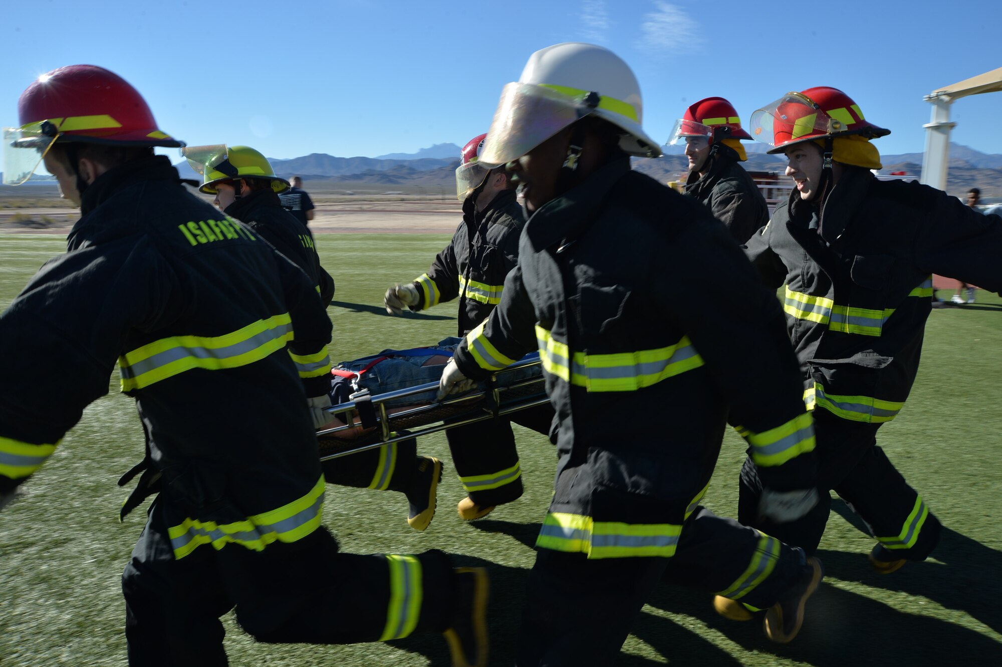 Airmen of Team Creech perform a litter carry at Creech Air Force Base, Nevada, Oct. 9, 2015. Over 12 teams competed in the event, which aims to spread fire prevention awareness through a series of firefighter related challenges.  (U.S. Air Force photo by Senior Airman Adarius Petty)