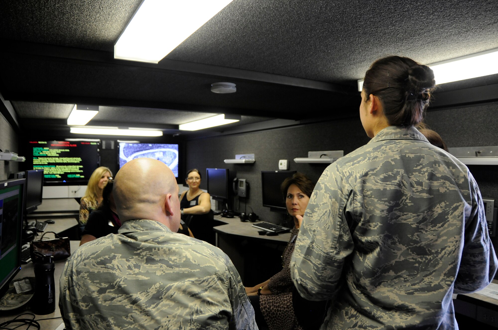 Airmen assigned to the 123rd Intelligence Squadron talk to members of Leadership Fort Smith about disaster relief capabilities at Ebbing Air National Guard Base, Ark., of the remote air, zonal operations, reach back-processing assessment and dissemination (RAZORPAD), Oct. 8, 2015. The RAZORPAD can assist workers on the ground with video from overhead aircraft to provide information of areas or people most in need. Base tours like this build and foster a positive working relationship with the city of Fort Smith and the surrounding communities, while keeping them informed of how we serve them. (U.S. Air National Guard photo by Staff Sgt. Hannah Dickerson/Released)