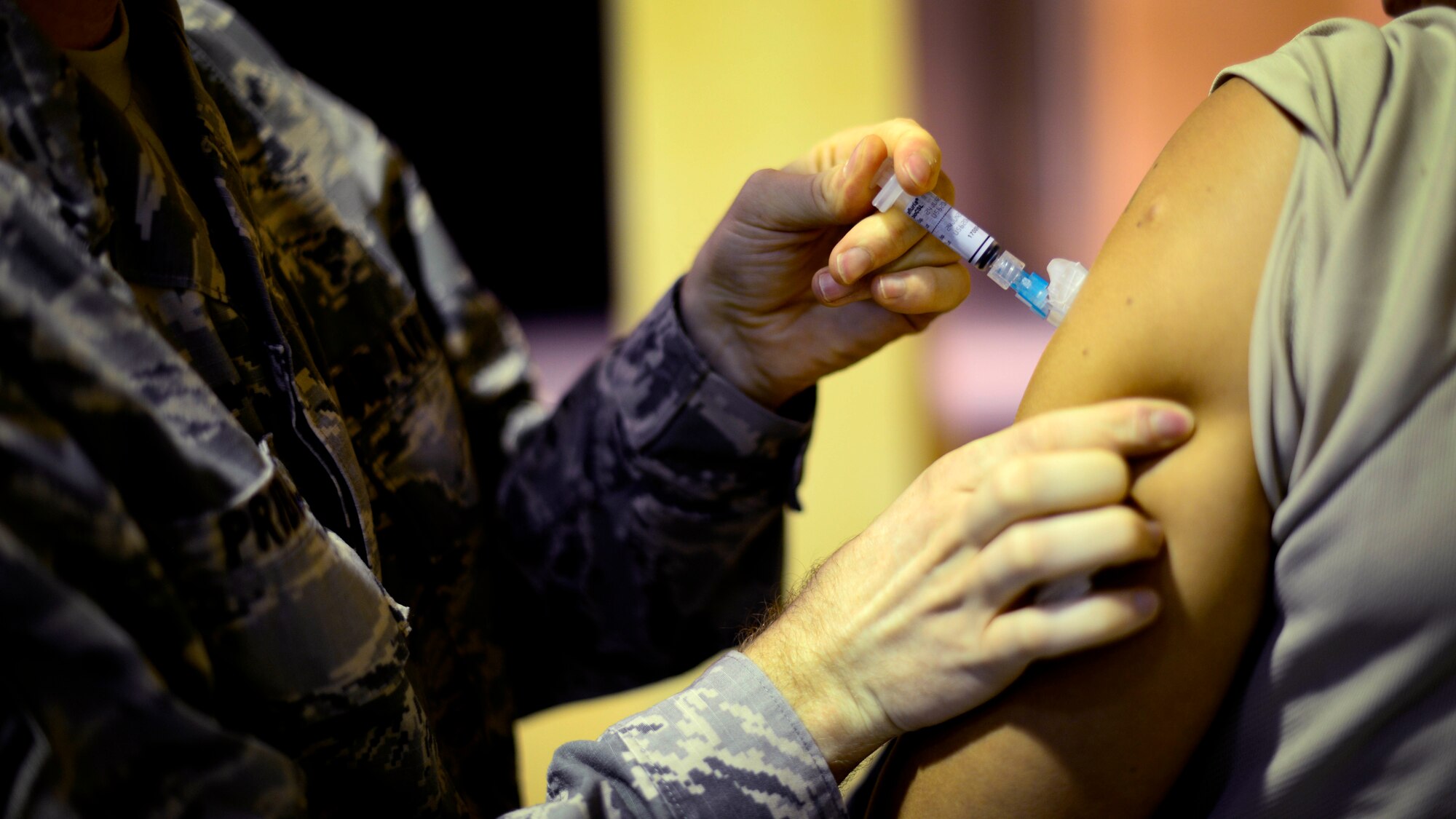 U.S. Air Force Staff Sgt. Justin Pribble, 31st Medical Operations Squadron allergy and immunizations NCO in charge, administers an influenza vaccine to a patient, Oct. 14, 2015, at Aviano Air Base, Italy. The vaccination is required for uniformed personnel and civilian healthcare employees working in patient care to help prevent influenza. (U.S. Air Force photo by Senior Airman Areca T. Bell/Released)                                                                                                                                                                                                                                                                                                                                                                                                                                                                                                        