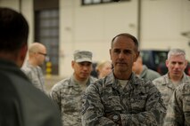 U.S. Air Force Chief Master Sgt. Pete Stone, USAF Expeditionary Center command chief, listens to a briefing outside the 726th Air Mobility Squadron building during a base visit Oct. 14, 2015, at Spangdahlem Air Base, Germany. Both Stone and Maj. Gen. Frederick Martin, USAF Expeditionary Center commander, received a briefing about the cargo capabilities of the 726th AMS as a part of their visit. (U.S. Air Force photo by Senior Airman Rusty Frank/Released)