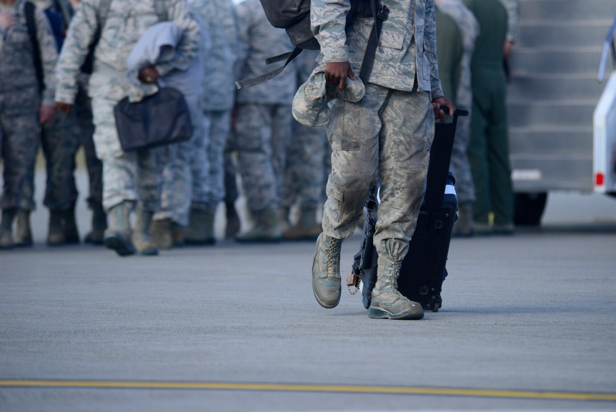 A 35th Fighter Wing Airman returning home from deployment pulls a bag behind him after being welcomed home by wind leadership at Misawa Air Base, Japan, Oct. 16, 2015.  The Airmen from Misawa are often deployed worldwide in support of operations requiring the need of the Wild Weasel mission of suppression of enemy air defenses. (U.S. Air Force photo by Tech. Sgt. April Quintanilla/Released)