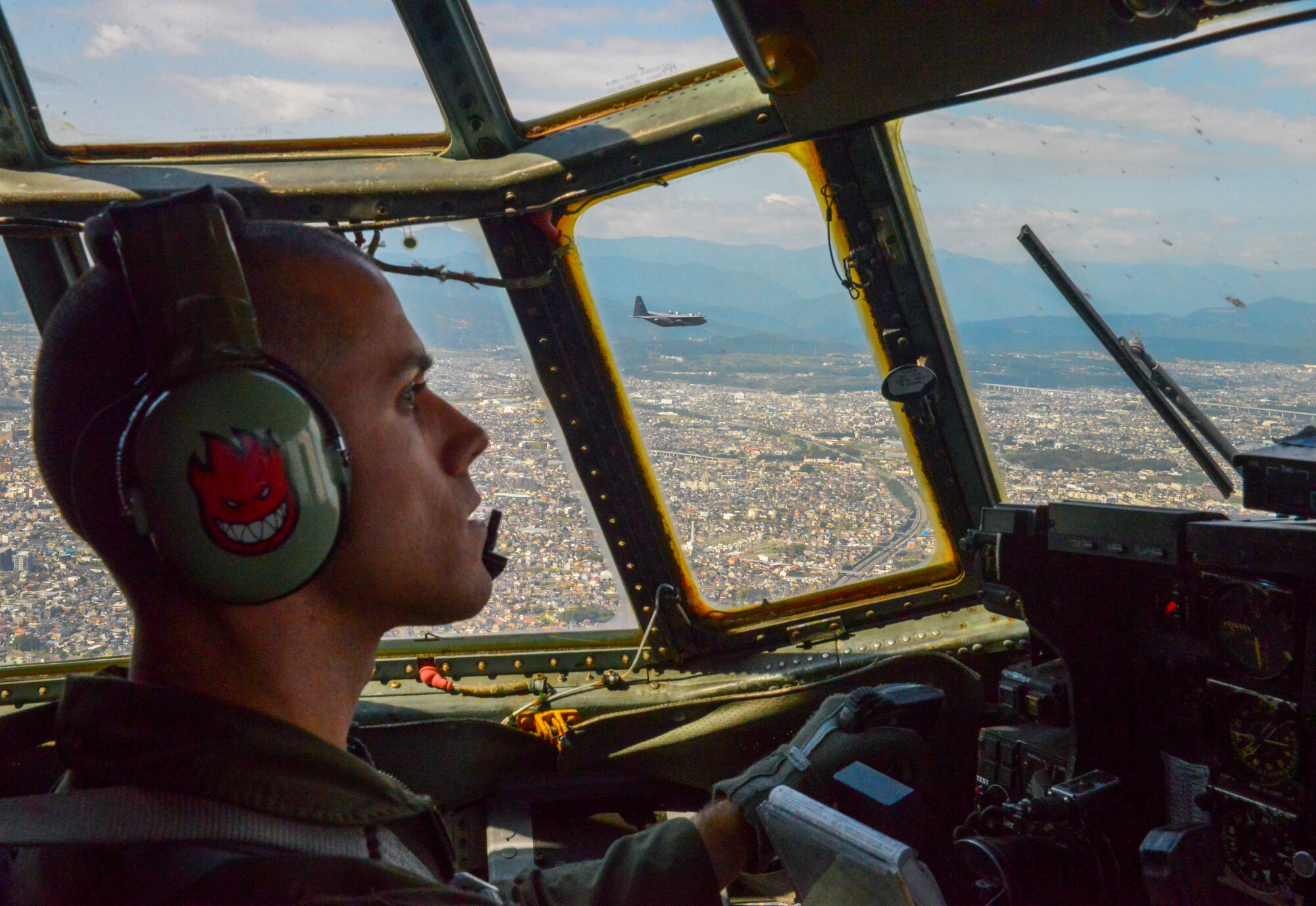 Capt. Matthieu Rigollet, 36th Airlift Squadron C-130 Hercules pilot, flies over Japan, Oct. 14, 2015. The crew flew past Mt. Fuji and performed a practice bundle drop as part of Yokota’s ongoing mission to keep all personnel ready to perform real world operations. (U.S. Air Force photo by Airman 1st Class Elizabeth Baker/Released)