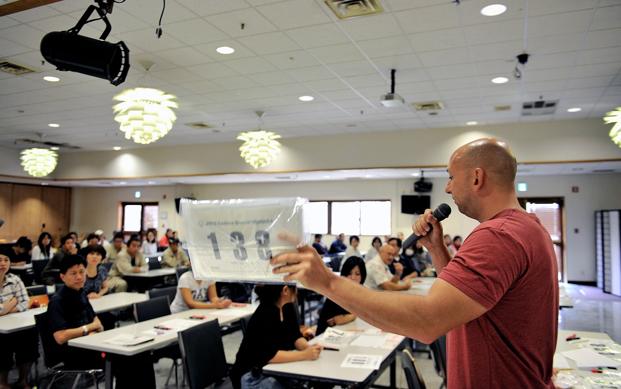 U.S. Air Force Master Sgt. Kevin Kasper, 18th Maintenance Group quality assurance munitions chief inspector, briefs volunteers in preparation for the Kadena Special Olympics at the Schilling Community Center on Kadena Air Base, Japan, Oct. 16, 2015. Approximately 70 volunteers participated in preparing for the upcoming 16th annual KSO scheduled for Nov. 7. (U.S. Air Force photo by Naoto Anazawa)