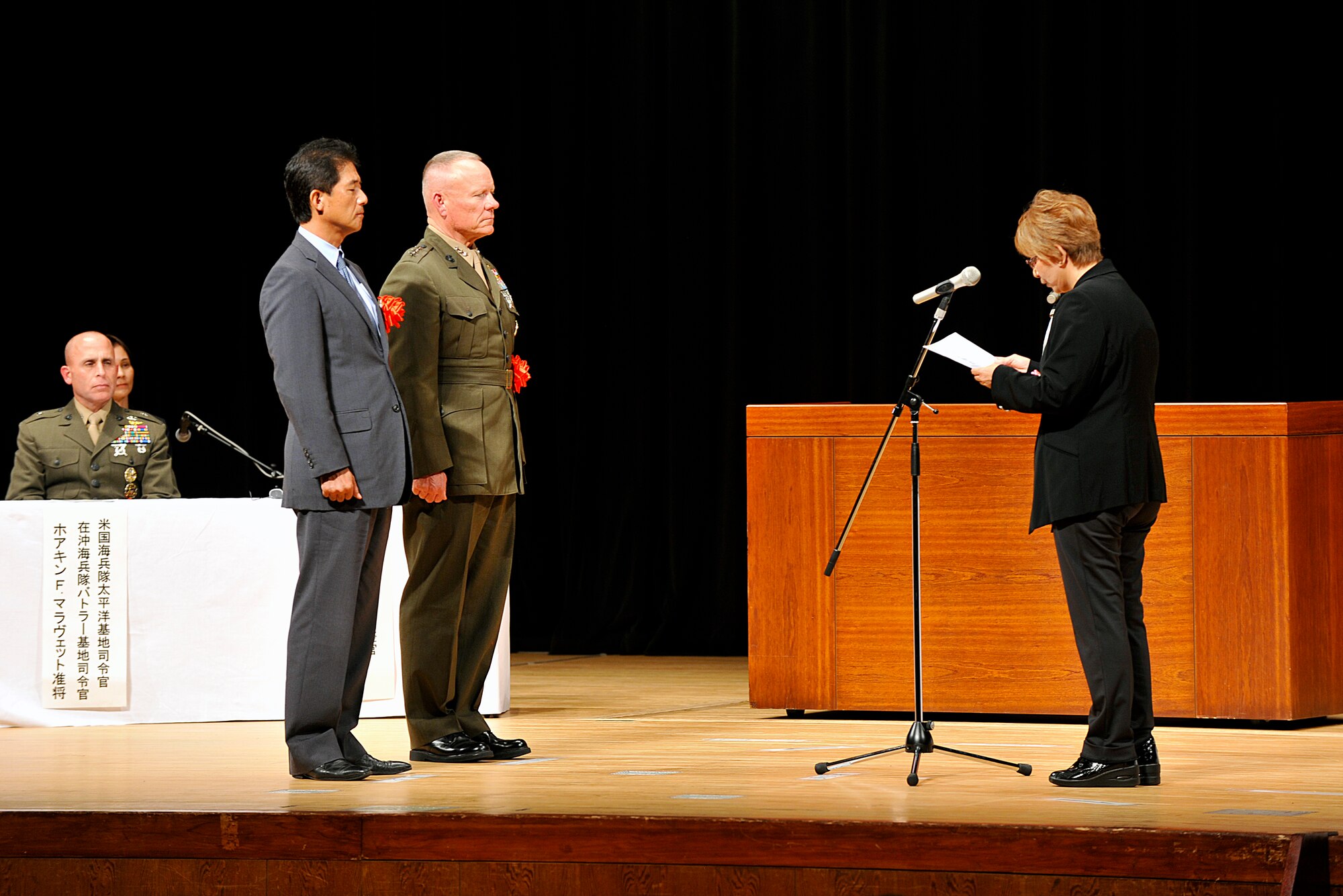 Kimiko Tomihira, 18th Contracting Squadron contracting officer, gives words of encouragement during a Joint Length of Service Award ceremony at the Okinawa Convention Center in Ginowan City, Japan, Oct. 15, 2015. During the ceremony, 723 U.S. Forces in Japan employees received a certificate of commendation and memorabilia for dedicating 10, 20, 30 or 40 years of service to USFJ facilities on Okinawa. (U.S. Air Force photo by Naoto Anazawa)