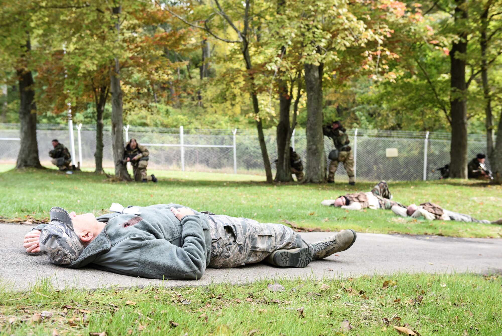 911th Airlift Wing Command Chief Master Sgt. Brian Zator lays motionless as he plays a hostage victim during an exercise here, Oct. 4, 2015. Security Forces Airmen set up a perimeter near hostage victims and attackers while the exercise was under way. (U.S. Air Force photo by Staff Sgt. Justyne Obeldobel)