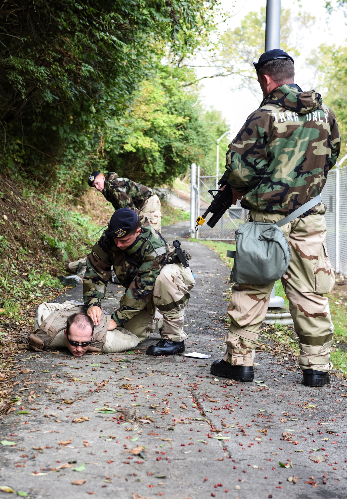 911th Airlift Wing Command Chief Master Sgt. Brian Zator lays motionless as he plays a hostage victim during an exercise here, Oct. 4, 2015. Security Forces Airmen set up a perimeter near hostage victims and attackers while the exercise was under way. (U.S. Air Force photo by Staff Sgt. Justyne Obeldobel)