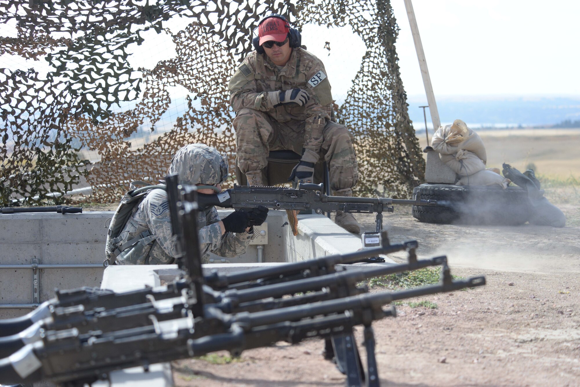 Staff Sgt. Amaris Serrano, 28th Security Forces Squadron Base Defense Operations Center controller, fires an M-240B at a target during the shooting range portion of the 2015 Global Strike Challenge security forces competition at Camp Guernsey, Wyo., Sept. 23, 2015. The challenge is designed to put the shooter under stress while they demonstrate skills and are judged on accuracy against fellow competitors. (U.S. Air Force photo by Senior Airman Brandon Valle/Released)