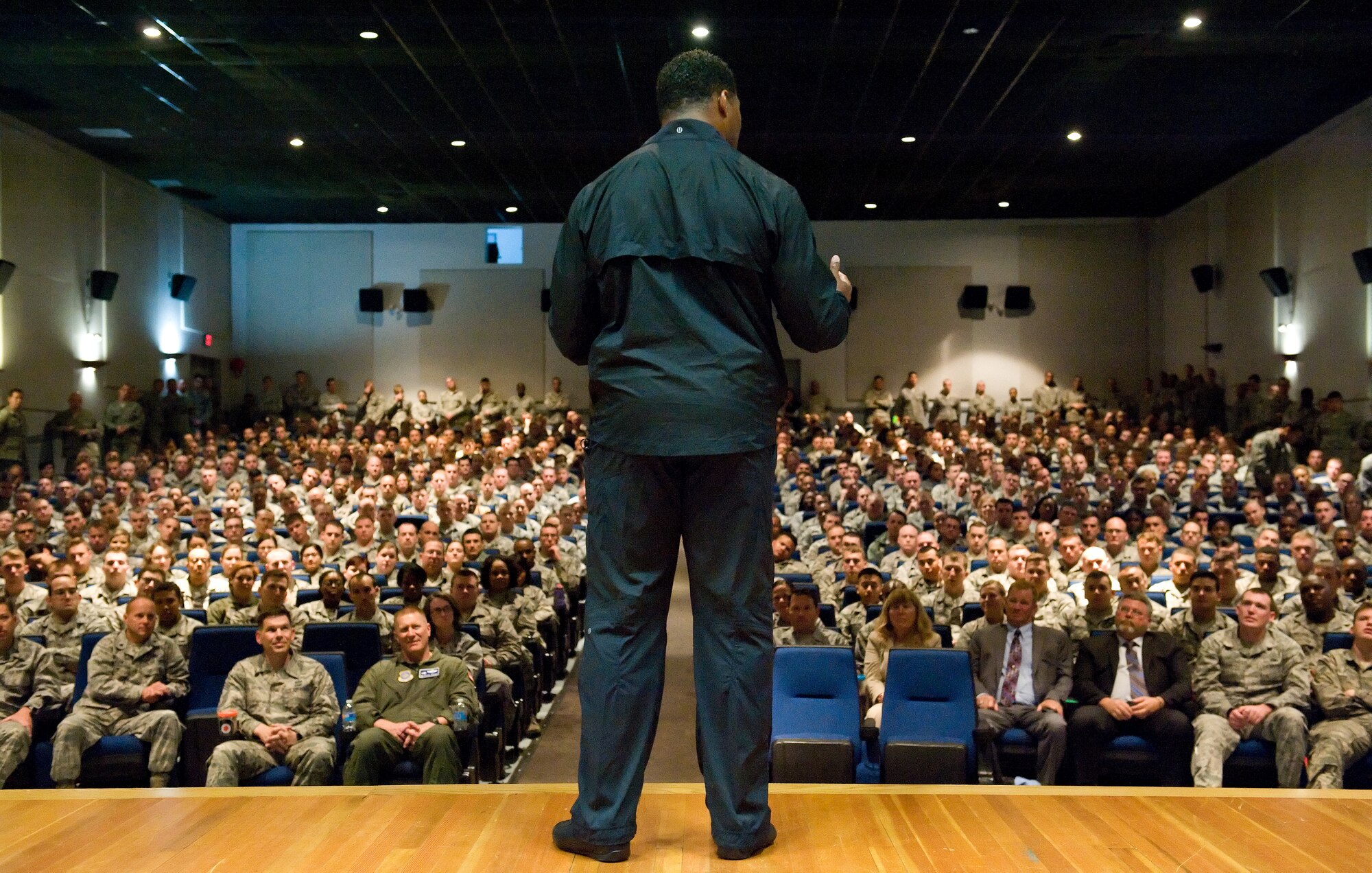 Speaking to a standing-room-only audience, former NFL running back and 1982 Heisman Trophy winner Herschel Walker speaks to military and civilian Airmen of Team Dover on Wingman Day Oct. 14, 2015, at the base theater on Dover Air Force Base, Del. Walker, who was diagnosed with Dissociative Identity Disorder, shared his own personal experience and treatment by seeking help through behavioral health services. In partnership with the Patriot Support Program and part of the program's anti-stigma campaign message, he emphasized to those in attendance that it is OK to ask for help. (U.S. Air Force photo/Roland Balik)