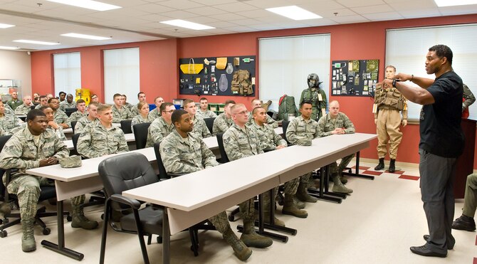 Herschel Walker, right, speaks to members of the 436th Operations Support Squadron Oct. 13, 2015, at the Aircrew Flight Equipment facility on Dover Air Force Base, Del. Walker and the Patriot Support Program's Anti-stigma campaign go around to military installations throughout the year. The Patriot Support Program is part of Universal Health Services, a TRICARE Provider. (U.S. Air Force photo/Roland Balik)