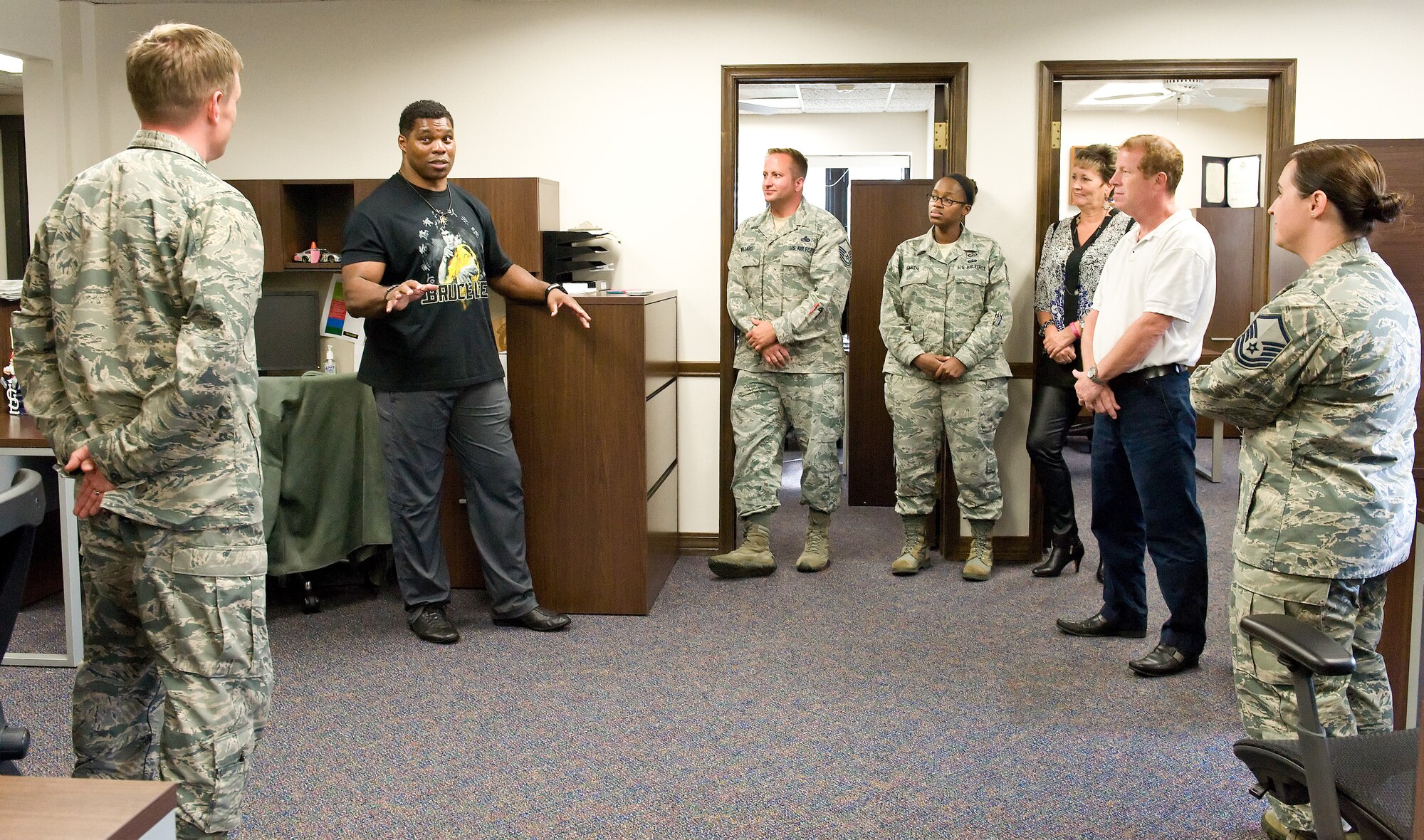 Herschel Walker, second from left, chats with members of the 436th Airlift Wing Safety Office Oct. 13, 2015, on Dover Air Force Base, Del. Walker shared stories about his upbringing, family, business and sports career, including his experience and treatment of Dissociative Identity Disorder by seeking the help of behavioral health professionals. (U.S. Air Force photo/Roland Balik)