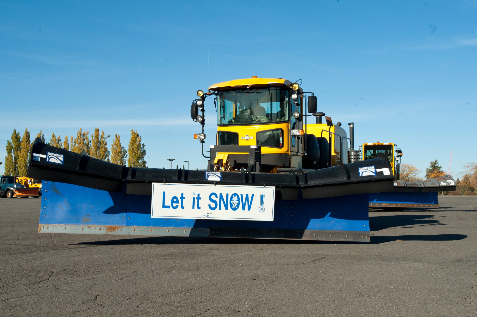 Twenty pieces of snow removal equipment leave the base headquarters to conduct the annual Fairchild tradition known as the “snow parade” Oct. 14, 2015, at Fairchild Air Force Base, Wash. The snow parade is an event that symbolizes the formal beginning of the snow removal season. (U.S. Air Force photo/Staff Sgt. Veronica Montes)