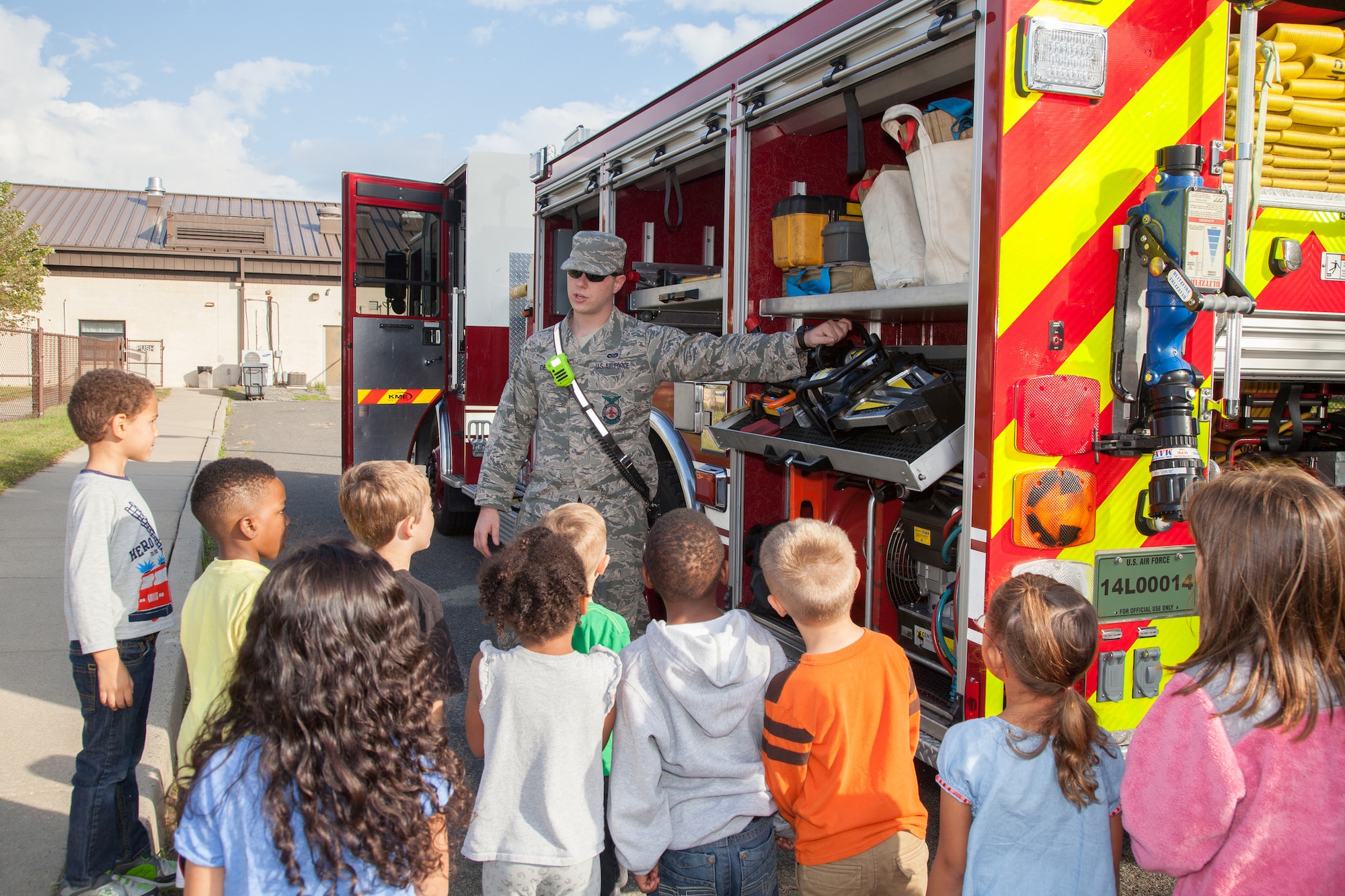Senior Airman Andrew Decker, 87th CES firefighter driver operator, shows the Jaws of Life tool to children at the Child Development Center at Joint Base McGuire-Dix-Lakehurst, N.J., Oct. 9, 2015.  Members of JB MDL Fire department visited the CDC during Fire Prevention Week. Decker hails from Scranton, Pa. (U.S. Air Force photo by Angela Squicciarini/Released)