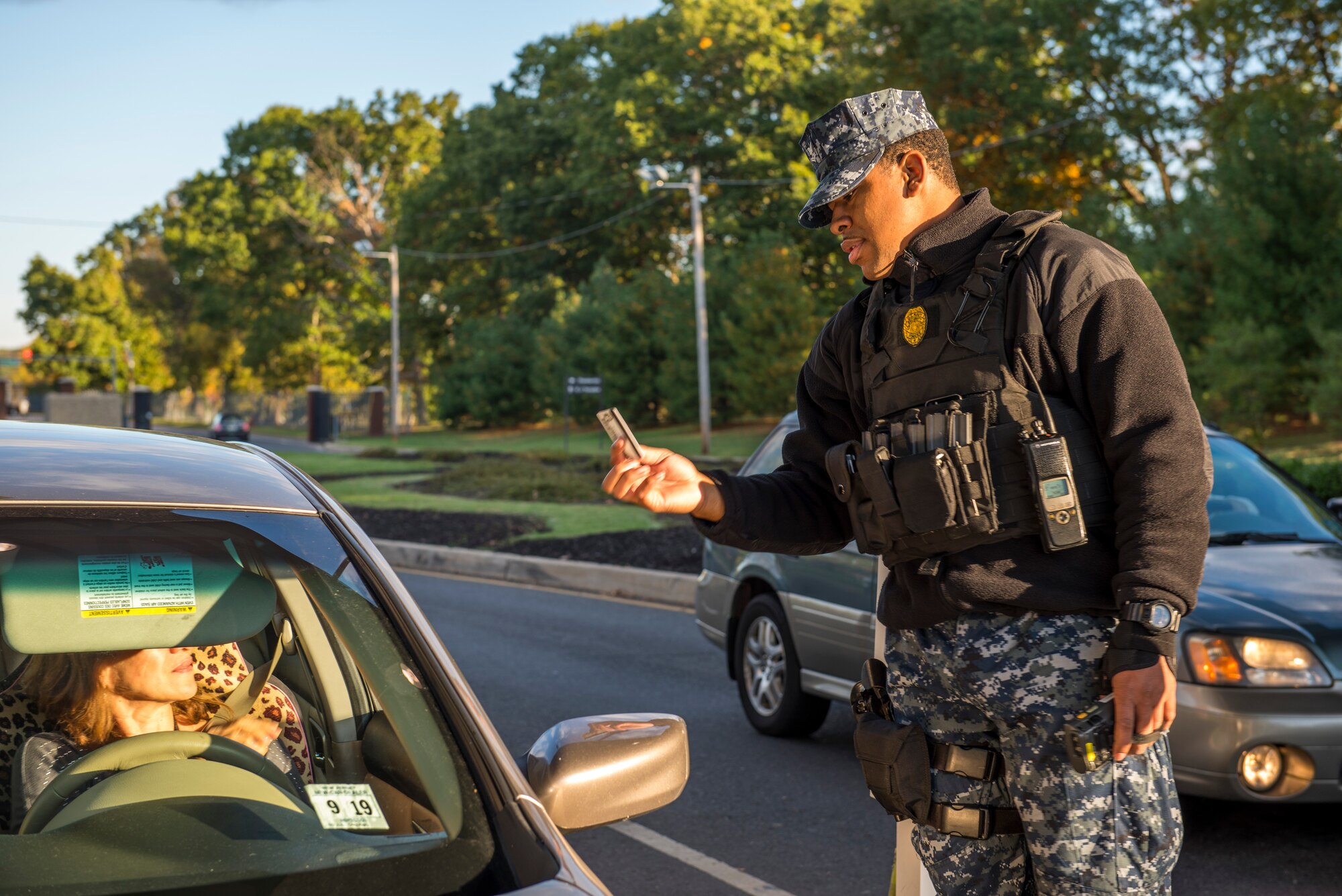 Petty Officer 2nd Class Anthony Repice, 87th Security Forces officer, checks IDs of personnel coming onto Joint Base McGuire-Dix-Lakehurst, N.J., Oct. 15, 2015. The U.S. Navy celebrated 240 years as a military service Oct. 13, while its dedicated Sailors remained on duty. (U.S. Air Force photo by Senior Airman Tara A. Williamson/Released)