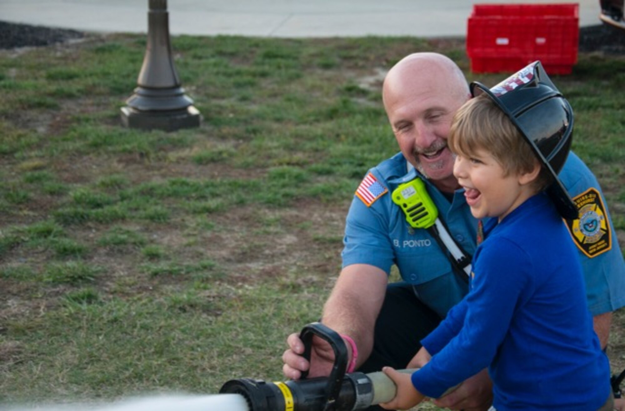Capt. Brad Ponto, Joint Base Fire Department, demonstrates to a child how to
aim a fire hose at an Open House during Fire Prevention Week at Joint Base
McGuire-Dix-Lakehurst, N.J., Oct. 7, 2015. The open house featured Sparky
the Fire Dog, rides in a fire truck, a smoke house, and information on fire
safety and prevention. (U.S. Air Force photo by Senior Airman Lauren
Pitts/Released)
