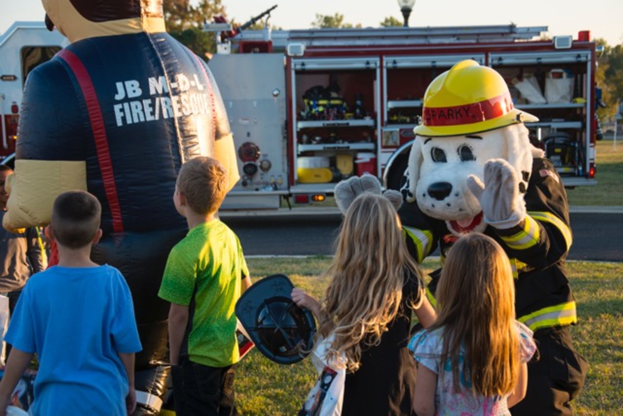 Sparky the Fire Dog high-fives children as they wait for a ride in a fire
truck during the Fire Prevention Week open house Joint Base
McGuire-Dix-Lakehurst, N.J., Oct. 7, 2015. Fire Prevention Week educates the
joint base community on proper safety and prevention techniques. (U.S. Air
Force photo by Senior Airman Lauren Pitts/Released)
