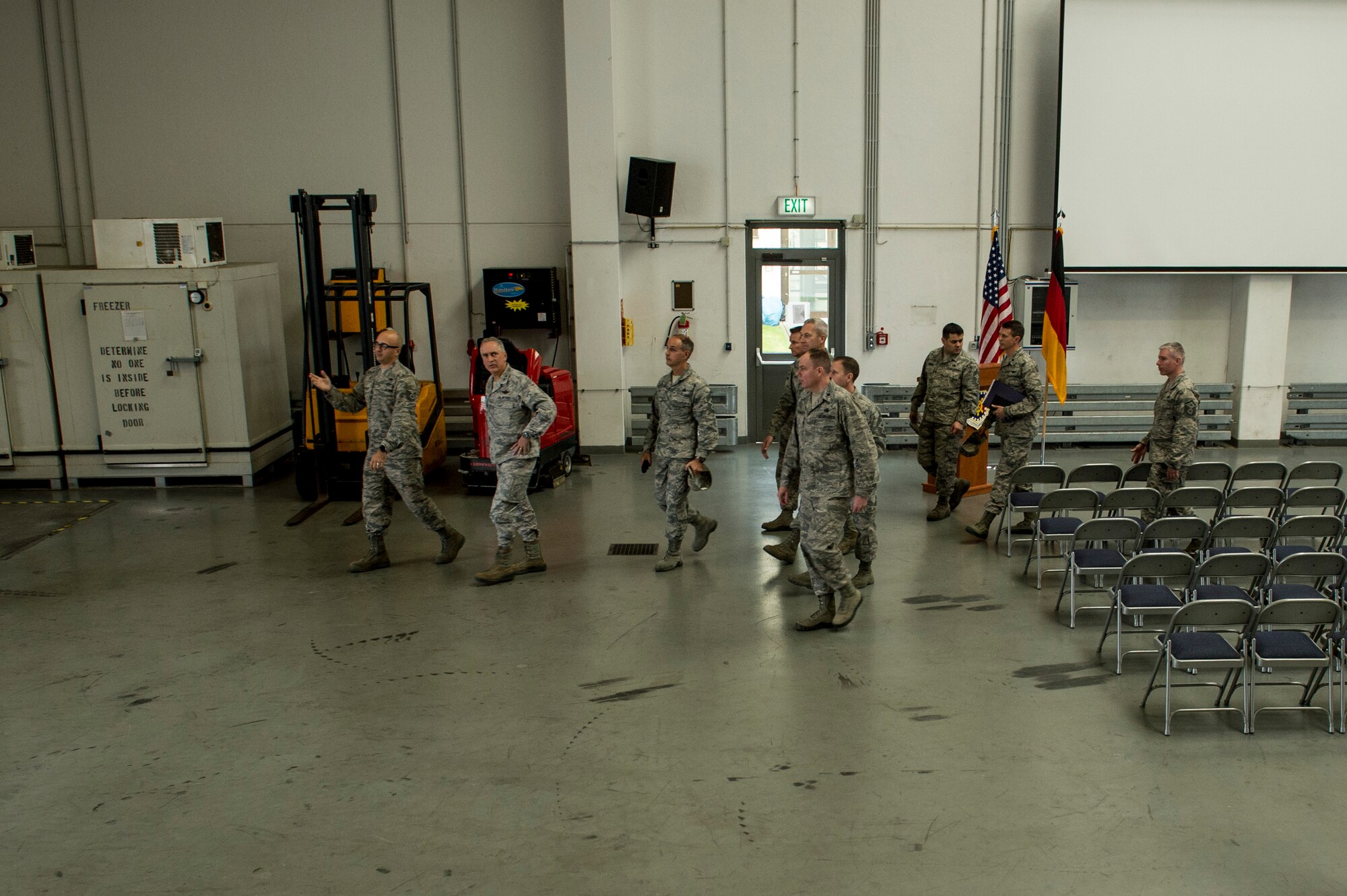 U.S. Air Force Tech. Sgt. Anthony Biecheler, 726th Air Mobility Squadron NCO-in-charge of aircraft services, briefs U.S. Air Force Maj. Gen. Frederick Martin, USAF Expeditionary Center commander and U.S. Air Force Chief Master Sgt. Pete Stone, USAF Expeditionary Center command chief inside a 726th AMS warehouse Oct. 14, 2015, at Spangdahlem Air Base, Germany. Biecheler briefed Martin and Stone on the cargo capabilities of the 726th AMS. (U.S. Air Force photo by Senior Airman Rusty Frank/Released)