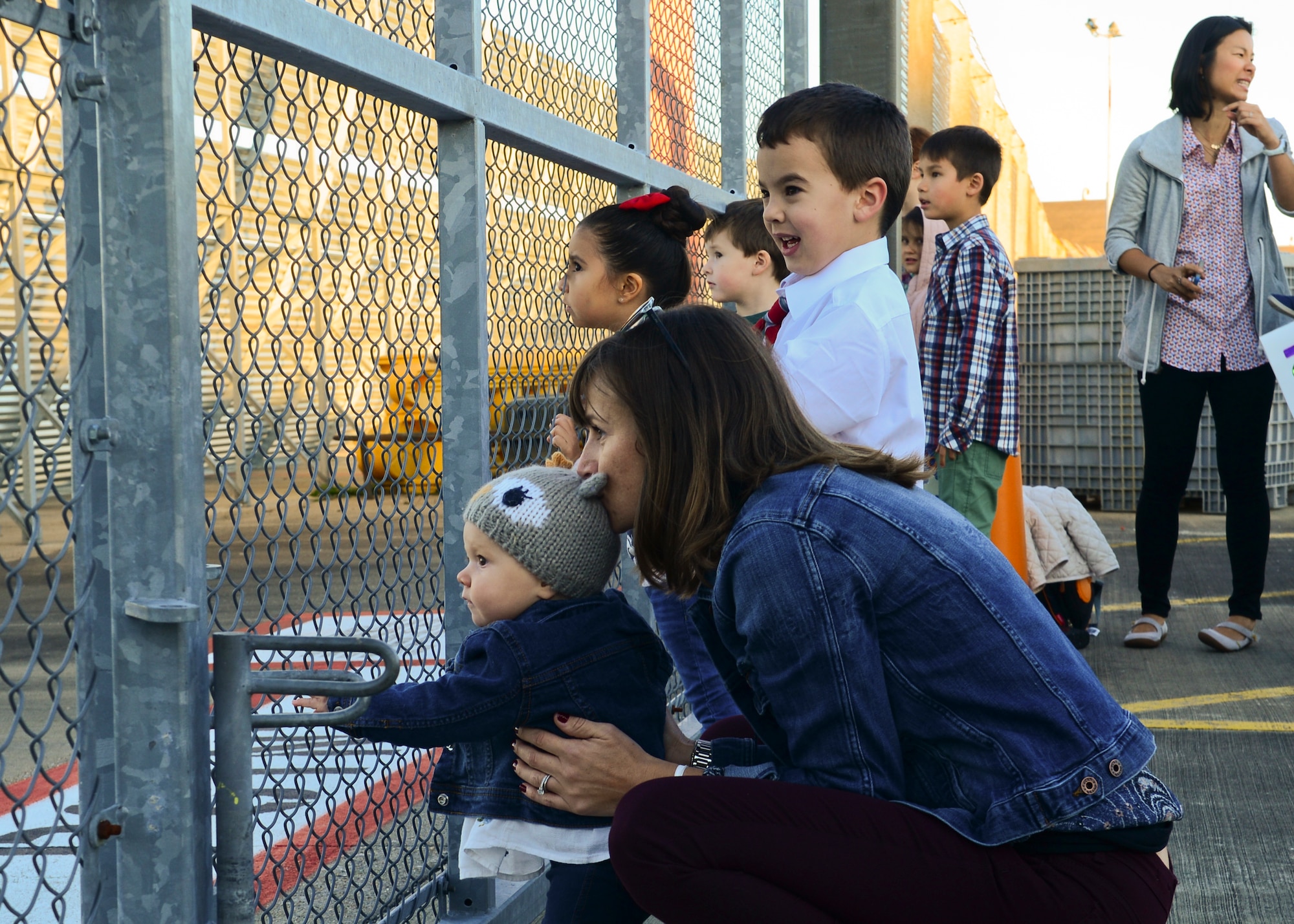 Family members gather on the RAF Lakenheath flightline Sept. 30, 2015, to welcome back Airmen of the 56th Rescue Squadron as they return from a deployment. The 56th and 57th RQSs deployed pilots, special mission aviators, pararescuemen and combat rescue officers, along with HH-60G Pave Hawk helicopters, supported by maintainers from various squadrons across the 48th Maintenance Group. (U.S. Air Force photo by Senior Airman Nigel Sandridge/Released)