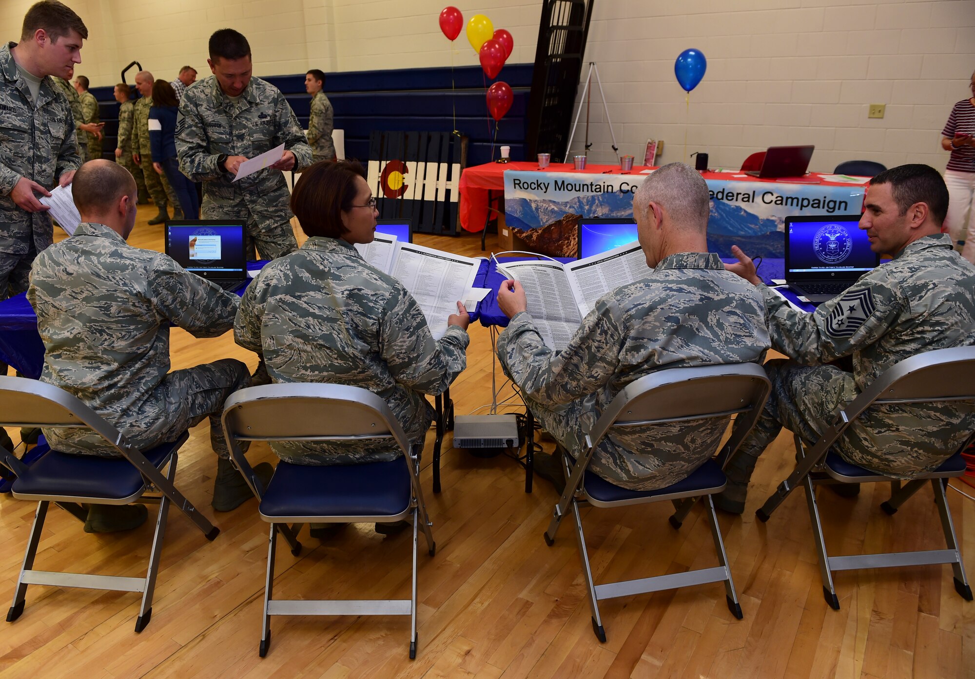 Members of wing leadership decide what charities to donate to at the Combined Federal Campaign Kick-off event Oct. 2015, 2015, at the Fitness Center on Buckley Air Force Base, Colo. The CFC is held annually to encourage federal employees to donate to the more than 16,000 participating non-profit agencies around the world. (U.S. Air Force photo by Senior Airman Phillip Houk/Released)