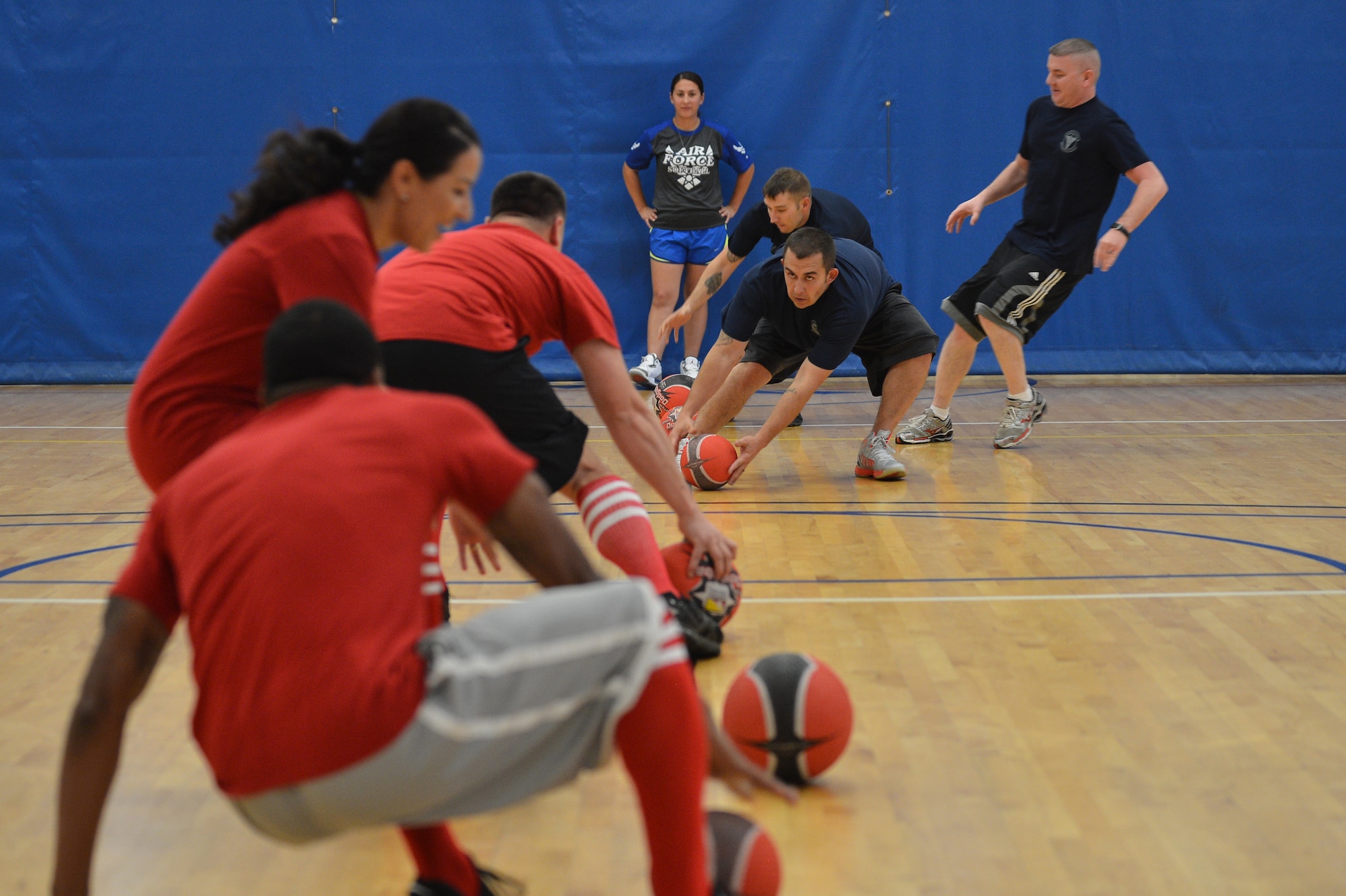 Two teams race to throw the first blow during the Combined Federal Campaign dodgeball tournament at the Fitness Center Oct.13, 2015, on Buckley Air Force Base, Colo. Seventeen teams signed up to compete in the tournament, which helped raise more than $400. (U.S. Air Force photo by Staff Sgt. Darren Scott/Released)