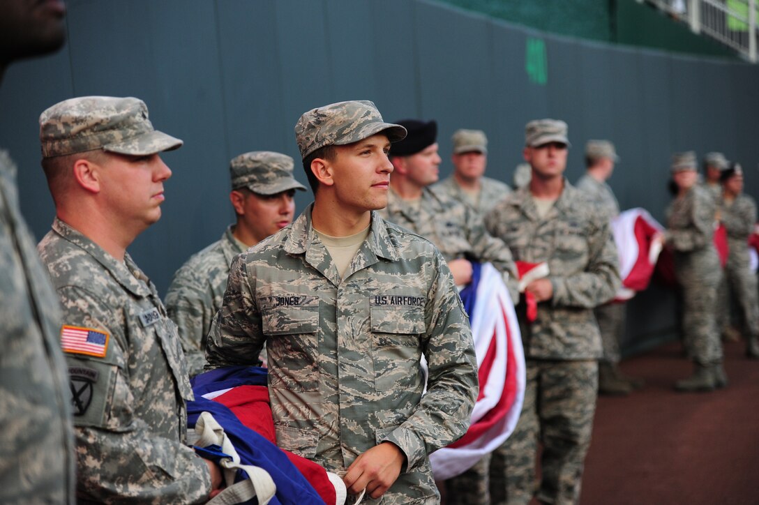 Airman 1st Class Corey Jones, 509th Operations Support Squadron air traffic control apprentice, looks at the crowd at Kauffman Stadium in Kansas City, Mo., Oct. 8, 2015. Airmen and Soldiers from Whiteman Air Force Base, Mo., participated in a flag ceremony before game one of the American League Divisional Series between the Houston Astros and the Kansas City Royals. (U.S. Air Force photo by Senior Airman Joel Pfiester/Released)