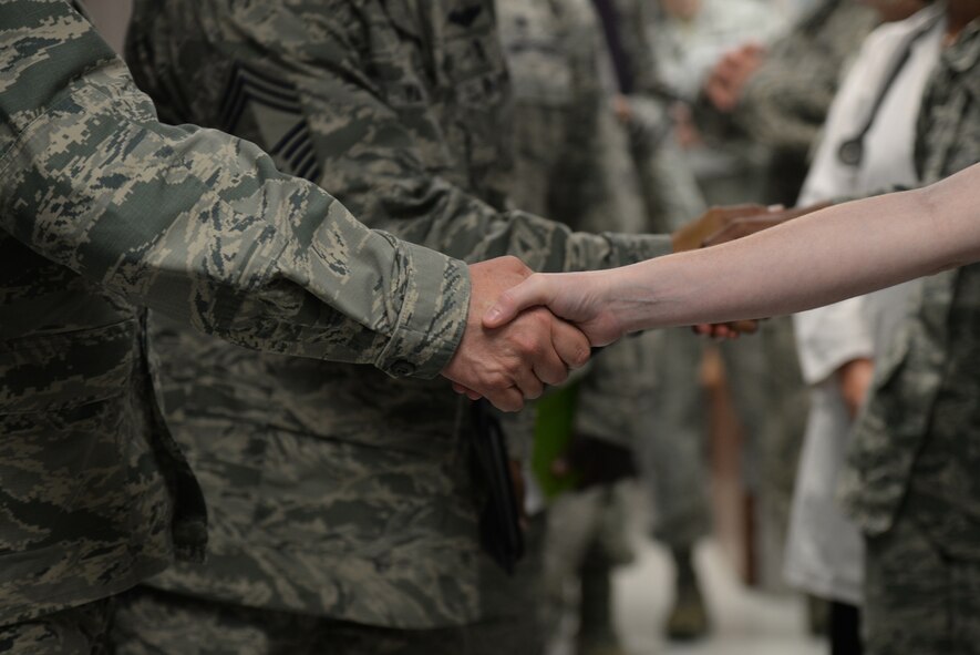 Brig. Gen. Lee Payne, Air Force Medical Operations Agency commander, shakes hands of members of the 47th Medical Group  during his tour of the medical facilities on Laughlin Air Force Base, Oct. 15, 2015. A recent study showed the 47th MDG holds the shortest average waiting time and has the highest percentage of patients returning to the same provider. (U.S. Air Force photo by Airman 1st Class Brandon May)