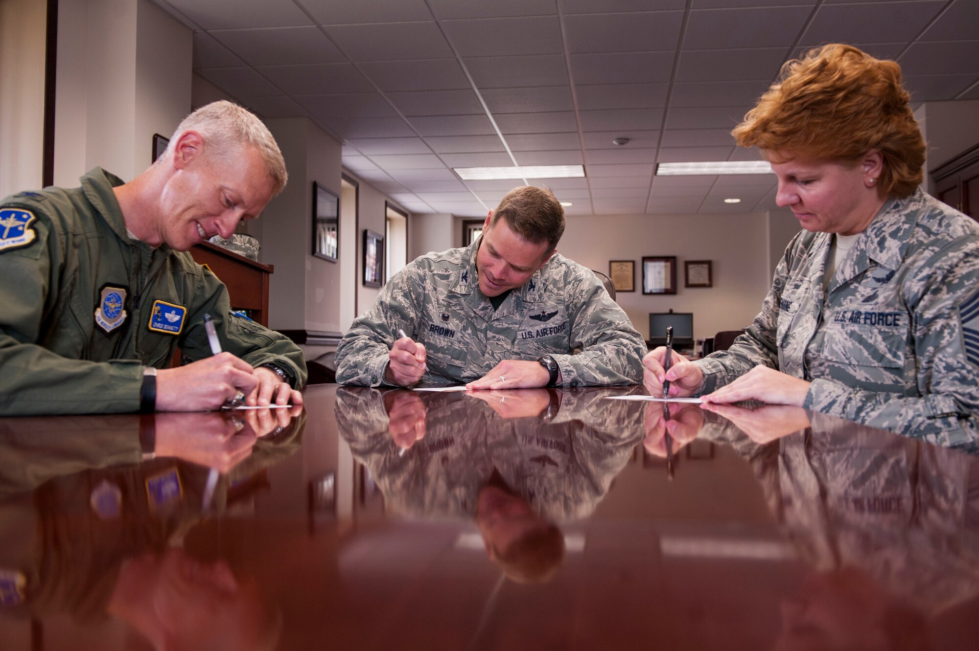 Col. Christopher Bennett, 19th Airlift Wing vice commander; Col. Charles Brown Jr., 19th Airlift Wing commander, and Chief Master Sgt. Rhonda Buening, 19th Airlift Wing command chief, fill out their Combined Federal Campaign cards Oct. 9 at Little Rock Air Force Base, Ark. (U.S. Air Force photo by Senior Airman Stephanie Serrano